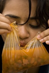 eating soup photo of girl eating soup out of a baggie